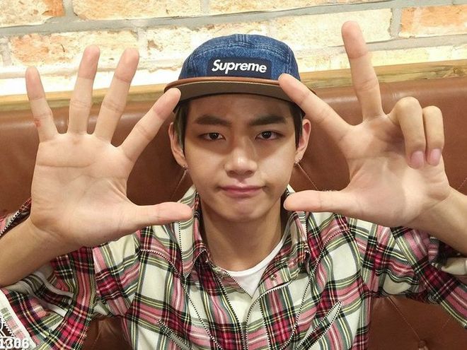 Kim Taehyung holding up his hands to the camera, showing 8 fingers, and making this face 🤨