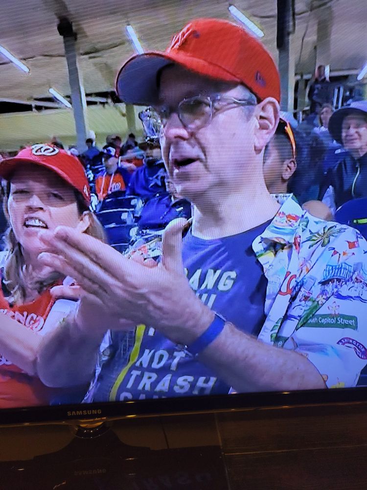 A man wearing a BANG FOUL POLES NOT TRASH CANS SHIRT.  AS A REMINDER THAT THE ASTROS CHEATED IN 2017 AND THE NATIONALS BEAT THEIR CHEATING ASSES IN 2019