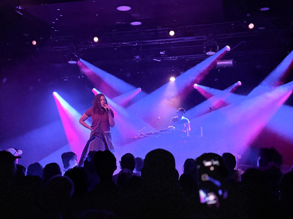 noname with a lot of spotlights shining behind her in different directions