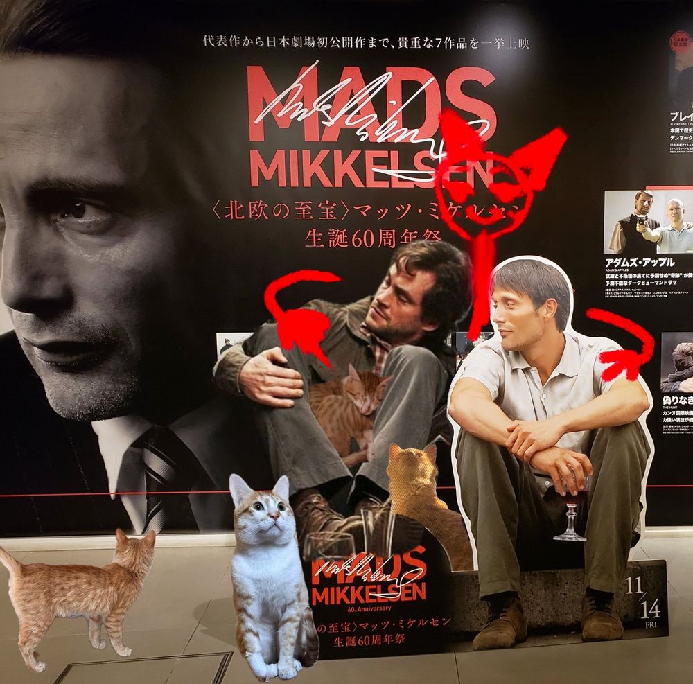  A Mads 60th anniversary banner in Tokyo, edited with my cats, Hugh Dancy, and me in red hugging them both.