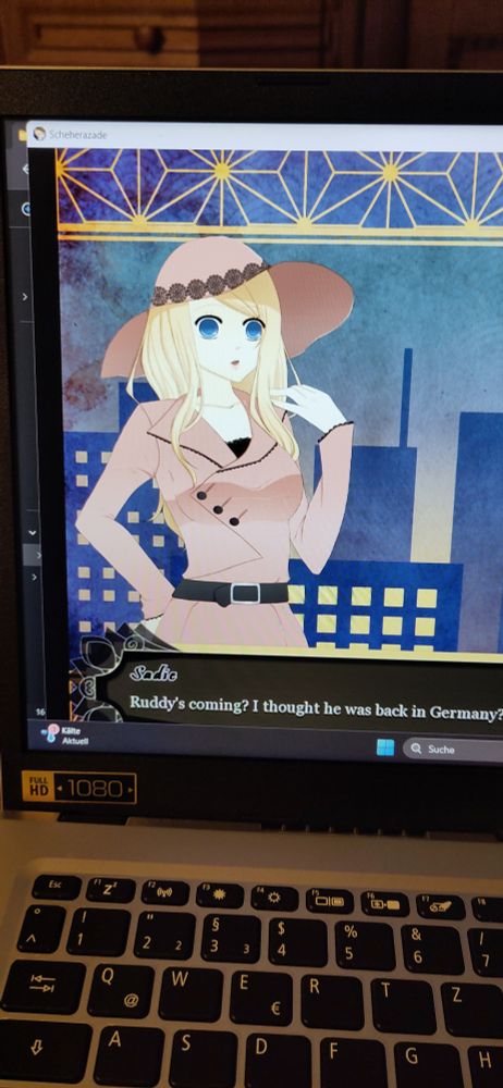 Das Spiel läuft, man sieht ein bissel Tastatur und Windows-Oberfläche und in der eigentlichen Anwendung die Hauptdarstellerin mit Dialogfeld.