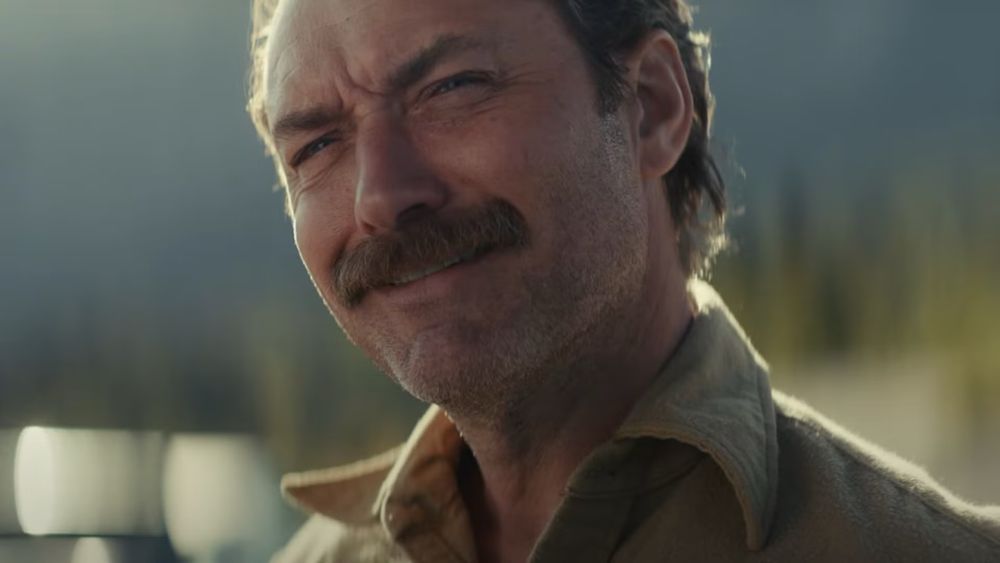 Jude Law in a still from 2024 film “The Order” (smirking)