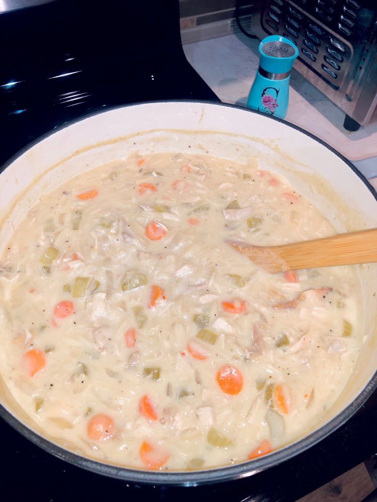 Pot of Avgolemono Soup on the stove. A lemony chicken soup with orzo. 