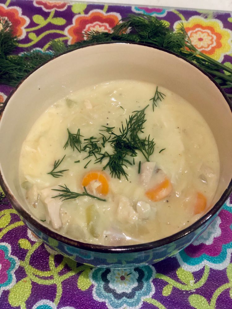 Bowl of Avgolemono Soup with fresh dill. 