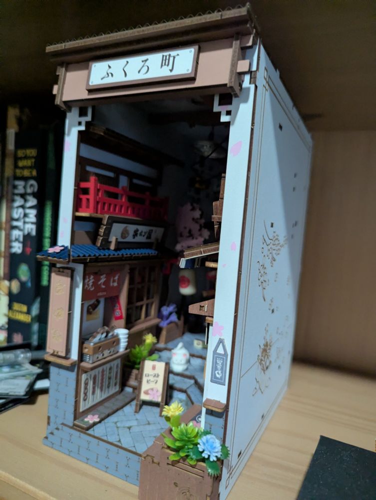 The same diorama with the light off in a lit room showing more of the outside detail from the other angle again.