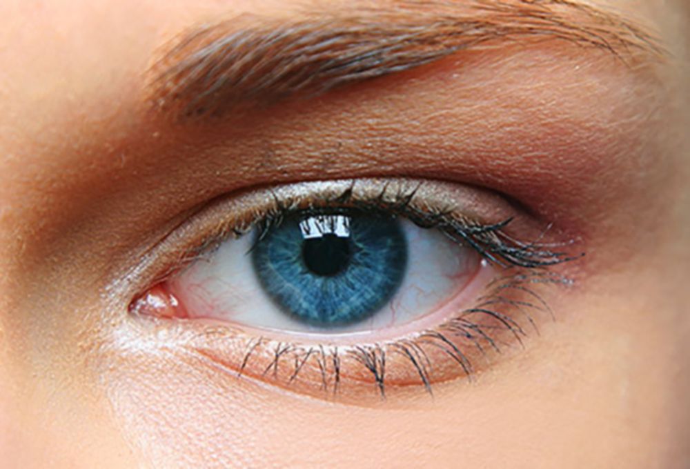 Close-up photograph of a person’s eye, with a vivid blue colouration.