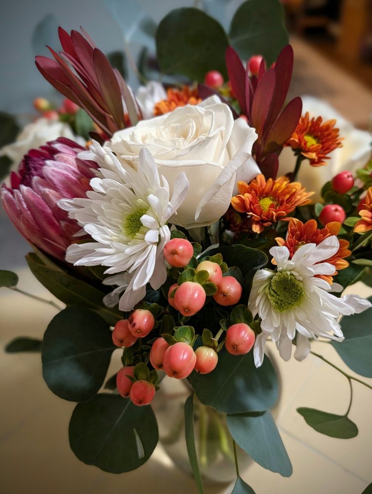 A fall-themed floral bouquet from Trader Joe's, styled in a glass vase