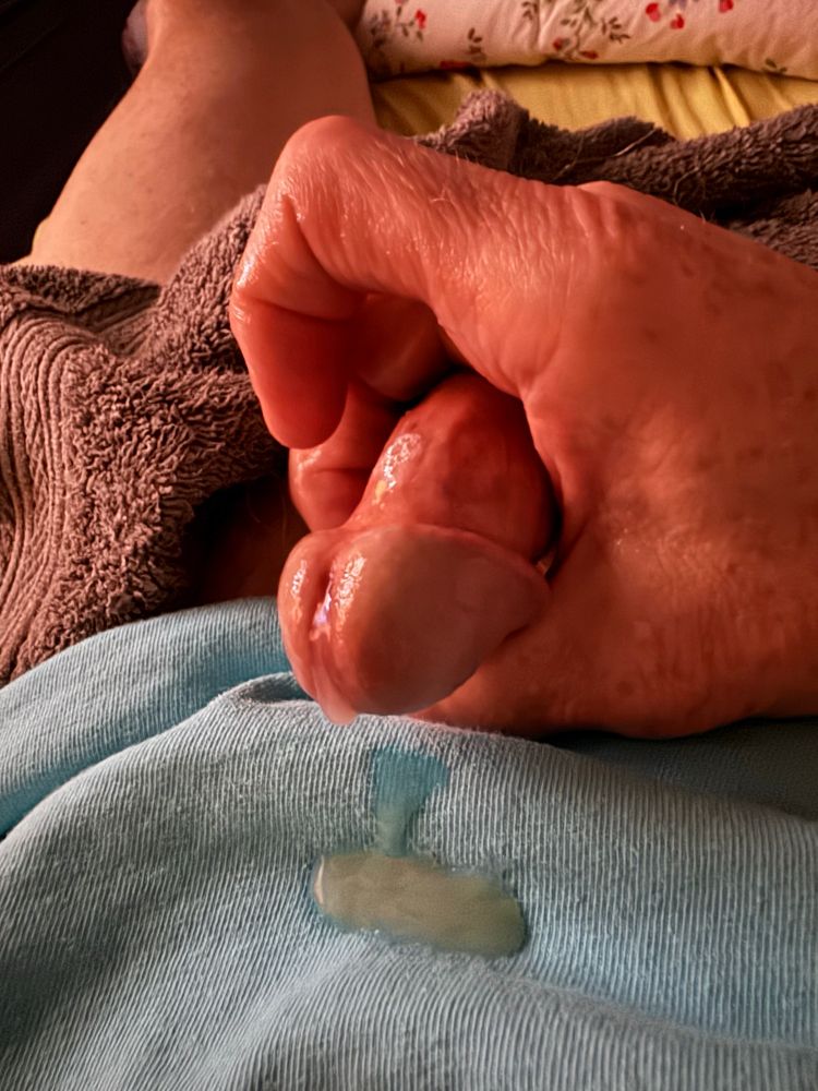 A close up of my lubed cock after shooting a load of cum onto my shirt