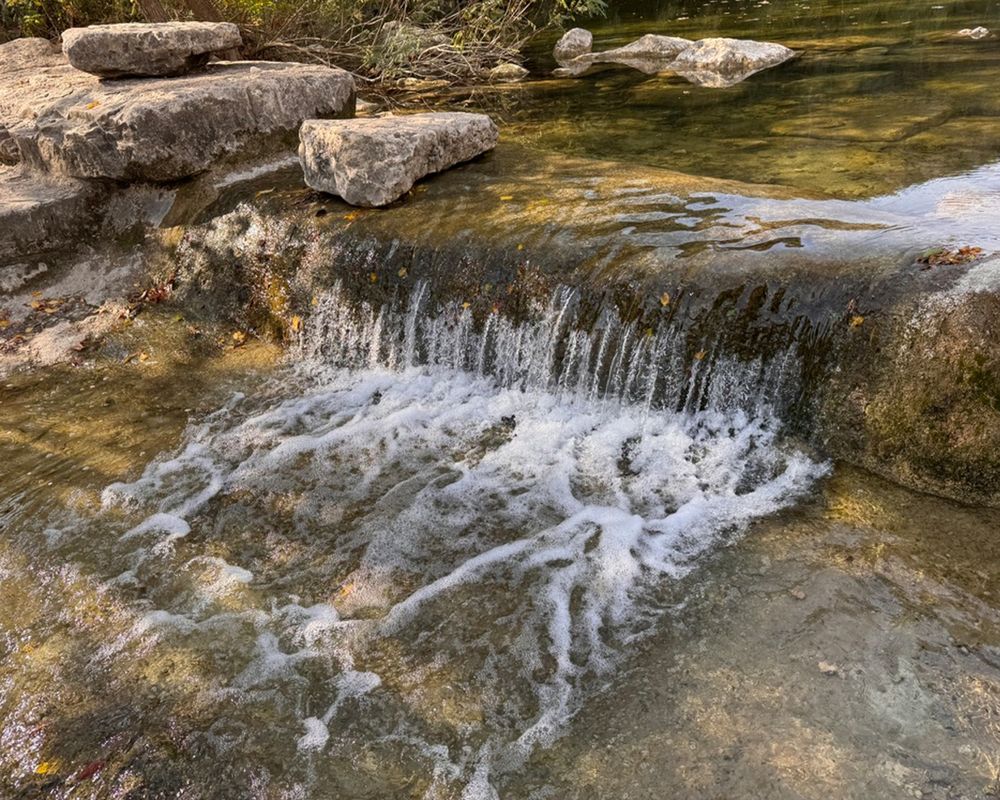 reference photo of a small waterfall in Barton Creek, Austin, Texas, USA