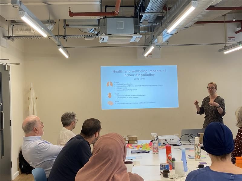 A group of people watching a presentation