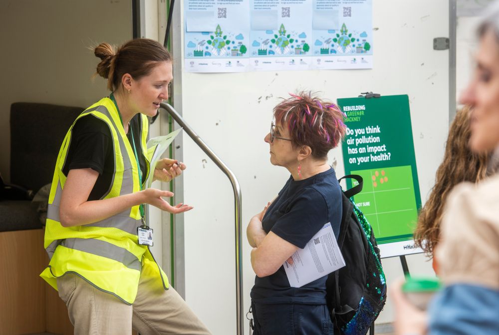 A member of Hackney Council's sustainability team talking to a woman at a Sustainability Day event
