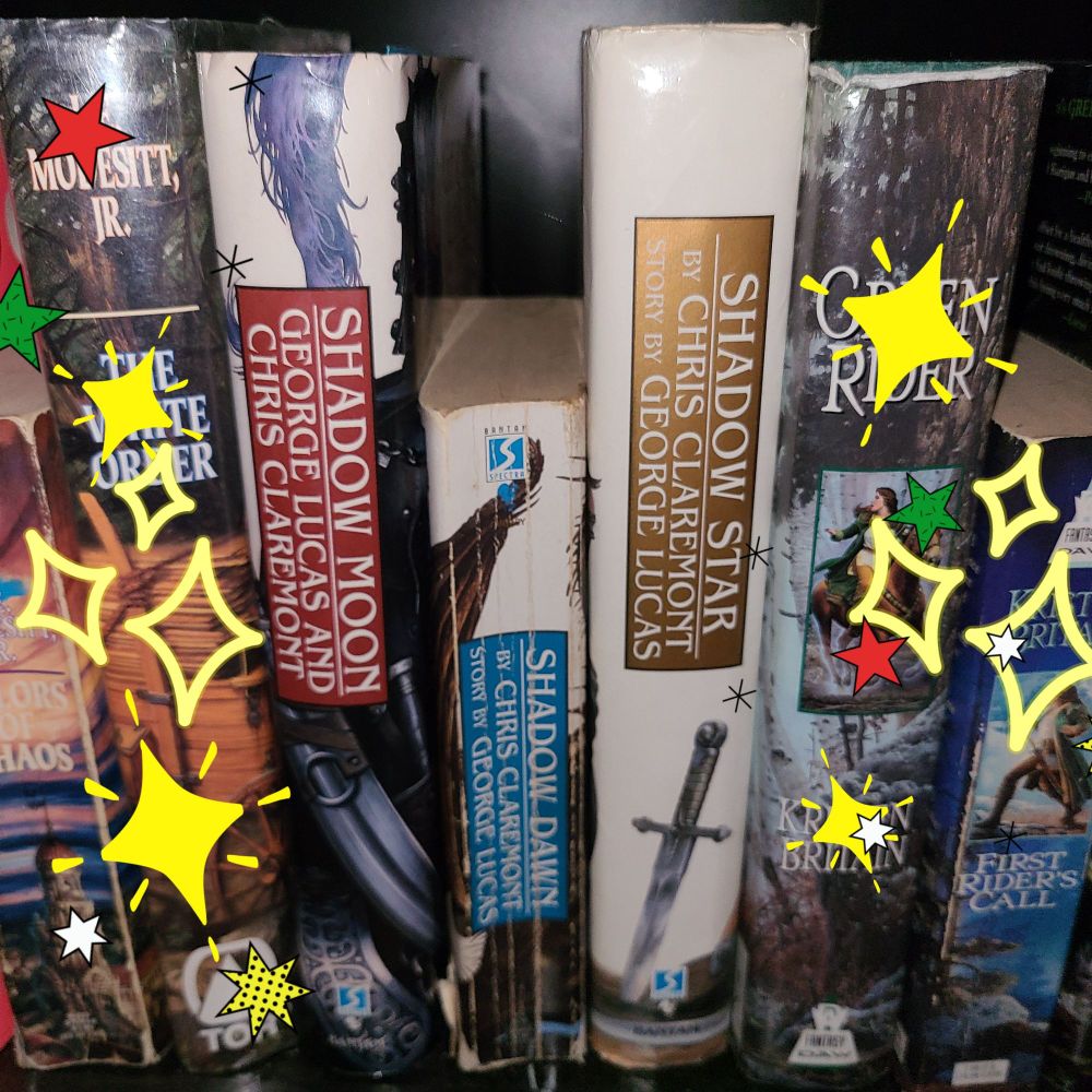 Picture of books on a bookshelf, with star stickers around the three being emphasized: Shadow Moon, Shadow Dawn, and Shadow Star (by Chris Clairmont and George Lucas)