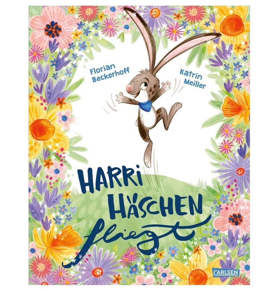 Picture book cover of the German picture book "Harri Häschen fliegt" - showing a little jumping easter bunny surrounded by a frame of beautiful spring flowers. 