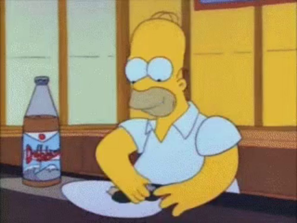 homer simpson is sitting at a table with a plate and a bottle of pepsi