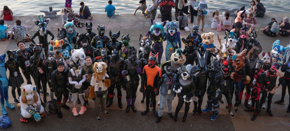 Latex creatures posing for a photo by the AC waterfront 