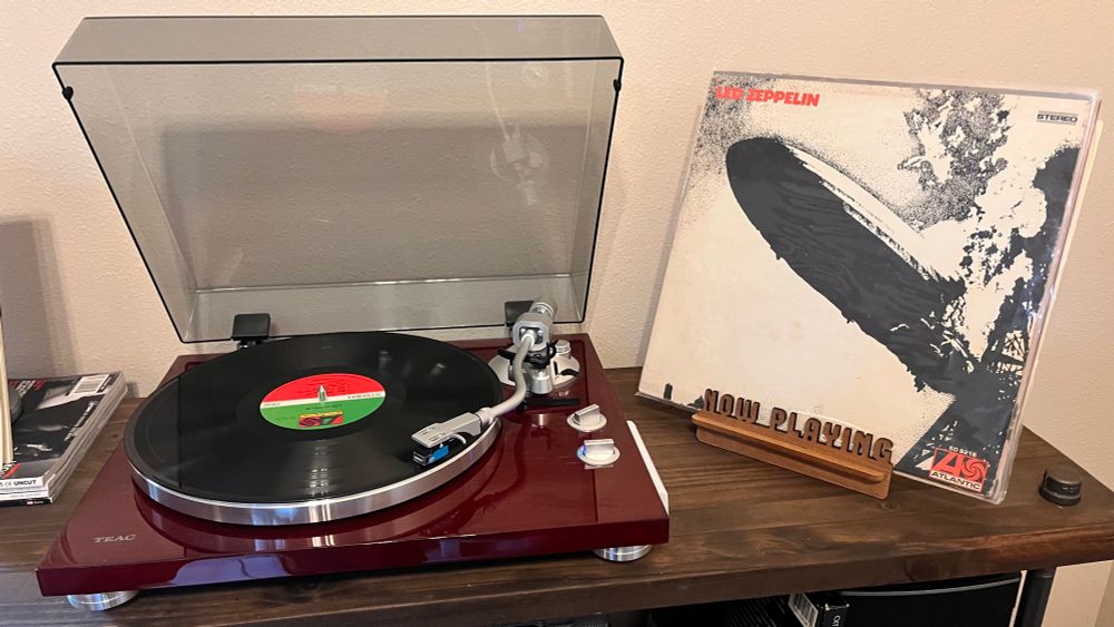 The first Led Zeppelin album playing in a turntable with the record jacket next to it. 