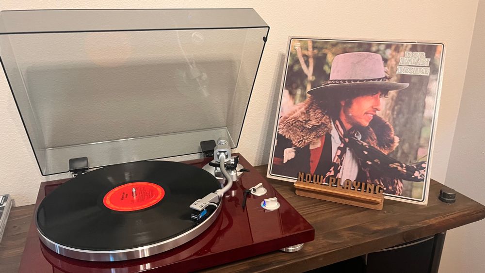 The Bob Dylan, Desire record playing on a turn table with the album cover next to it. 