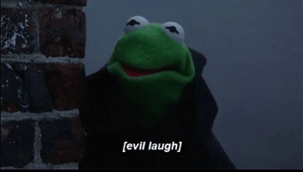 caption of “evil laugh” over evil Kermit in a hooded black robe, hood off, peering from behind the corner of a brick wall