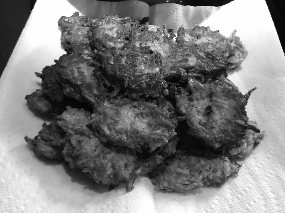 Malanga fritters on a paper towel (in grayscale)
