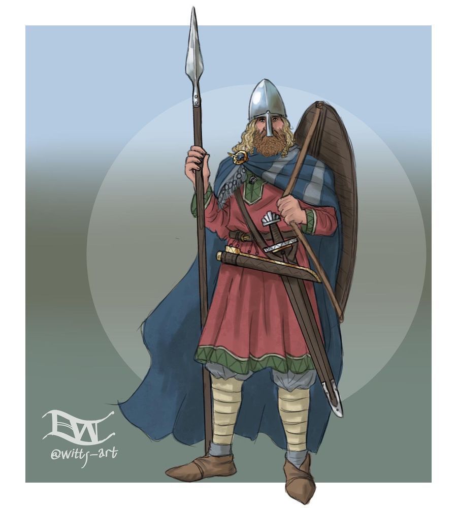 A 10th century Norseman with shoulder length blond hair and a light brown beard. He has a nasal helm on his head, and carries a spear, shield, knife, and lobe-pommel sword. 