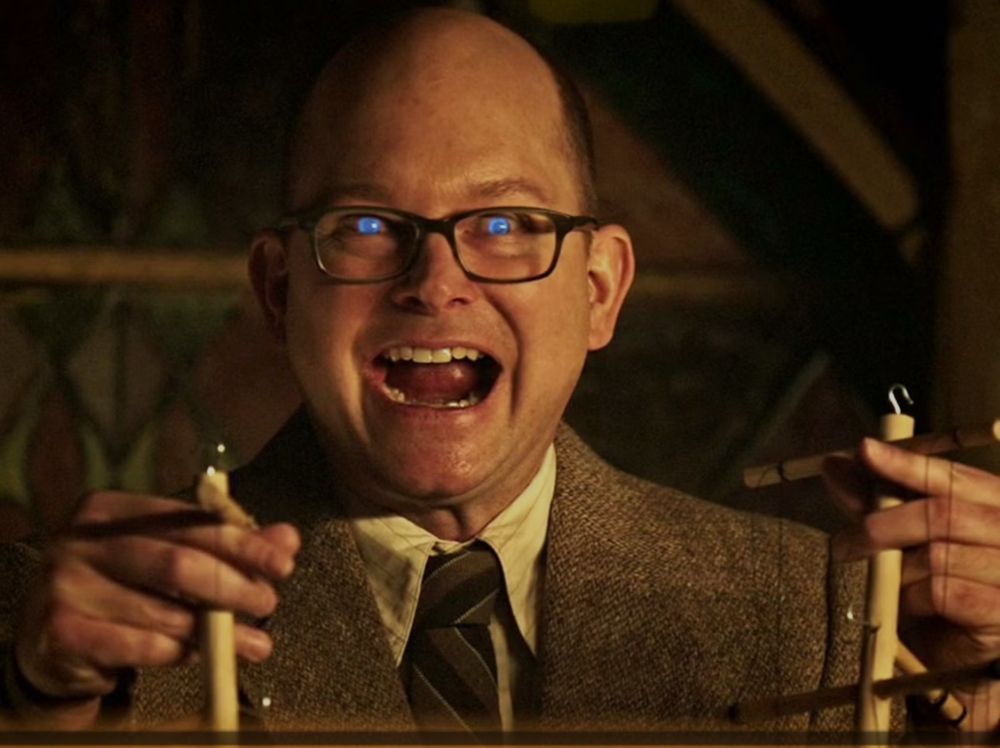 Man with glowing eyes and a crazy smile 