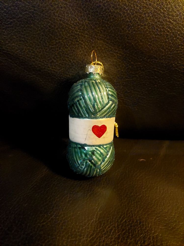 a blue yarn ornament with a heart