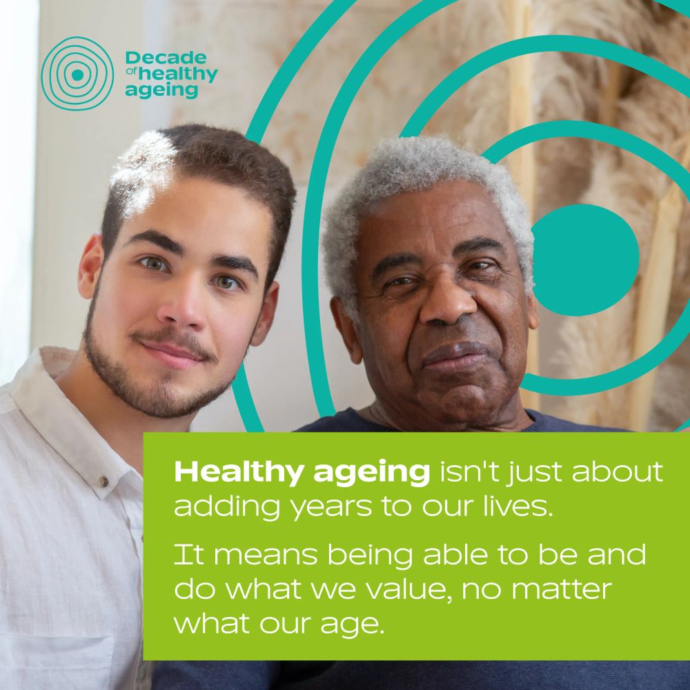 An older man sitting beside a younger man, both smiling at the camera. The UN Decade of Healthy Ageing logo is in the background.  Text: 'Healthy ageing isn't just about adding years to our lives. It means being able to be and do what we value, no matter what our age.'