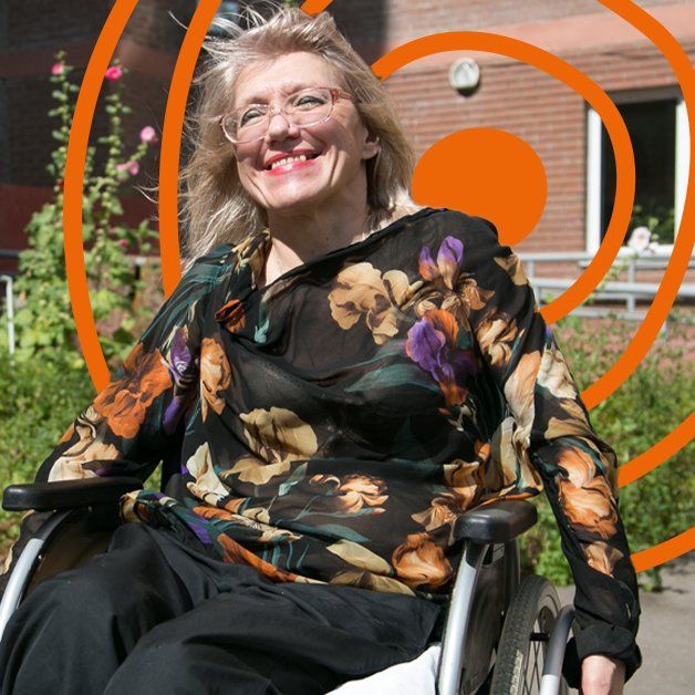 An older woman using a wheelchair to be mobile, smiling. The UN Decade of Healthy Ageing logo is in the background.  Photo credit: Sergey Volkov / WHO