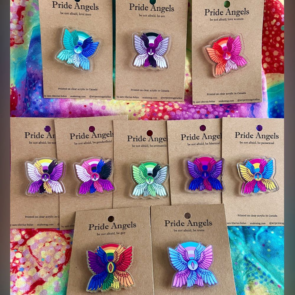 A collection of acrylic pins of angels all representing various pride flags