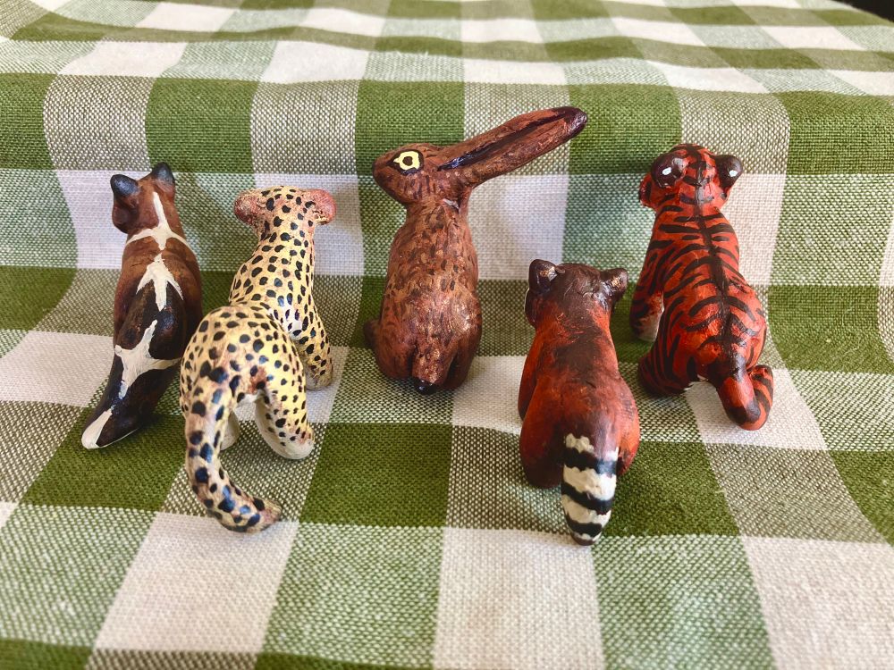 A collection of mini sculptures made with polymer clay and painted with acrylic paint