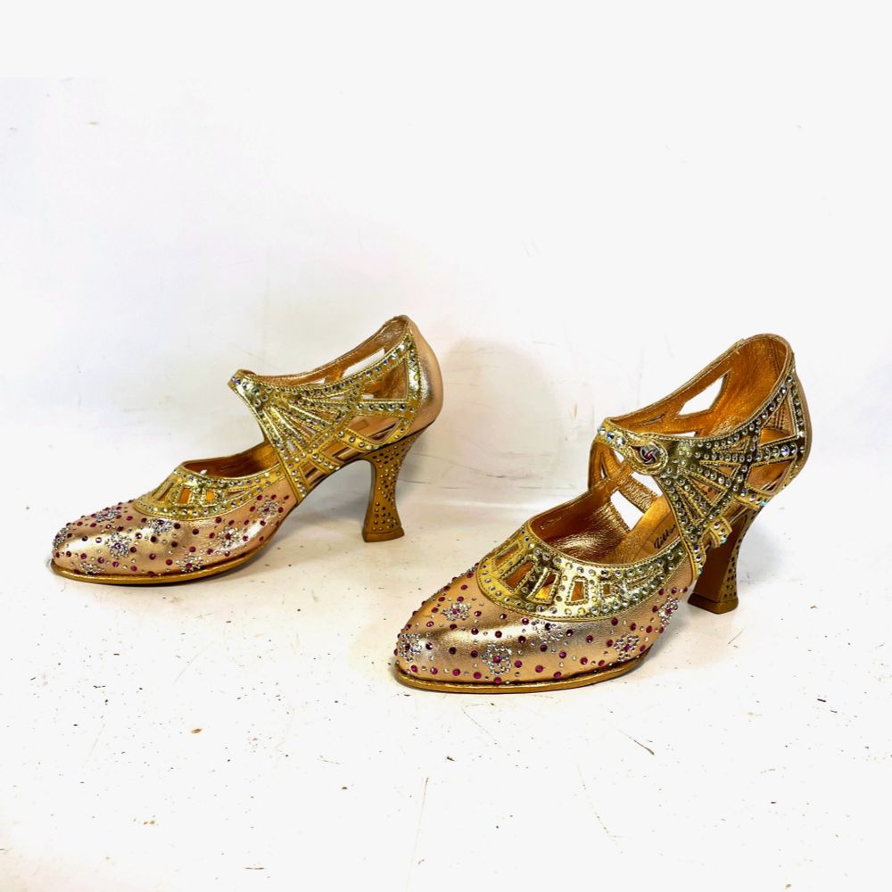 A pair of Glinda's shoes, heavily jeweled, from the new Wicked film. 