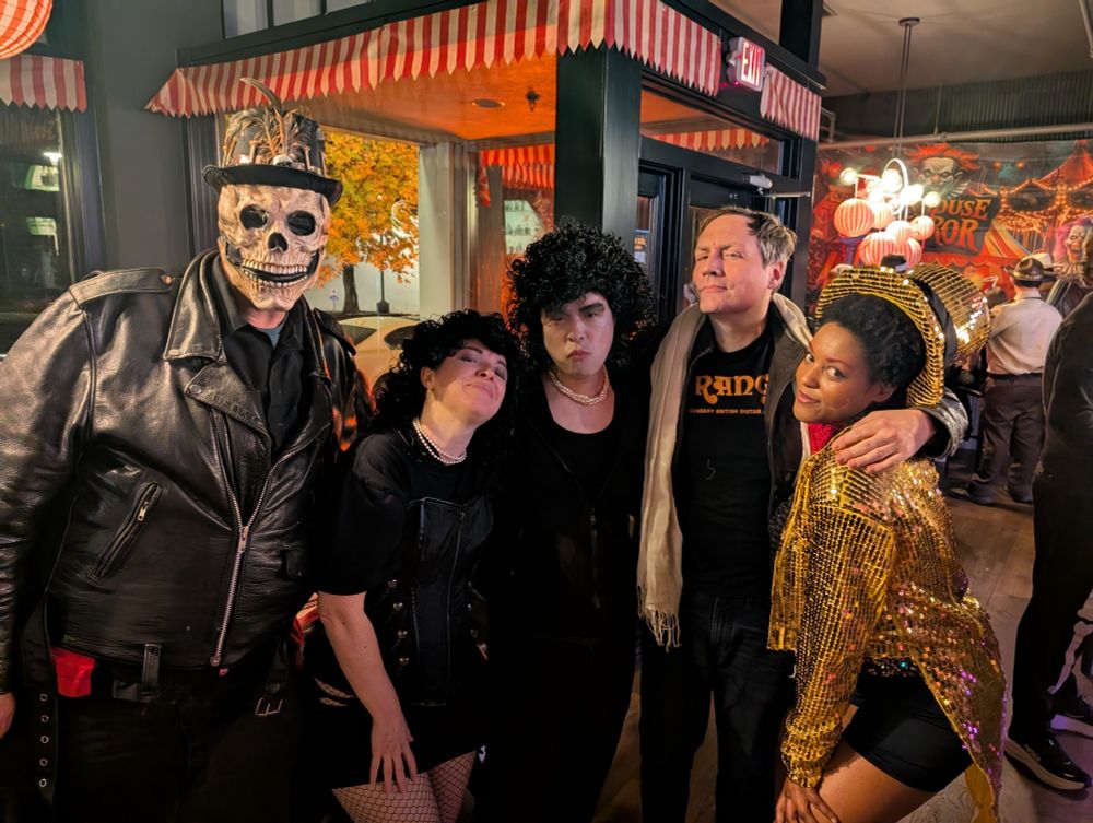 a few goons dressed up as various characters from rocky horror picture show (and i guess a witch doctor?)