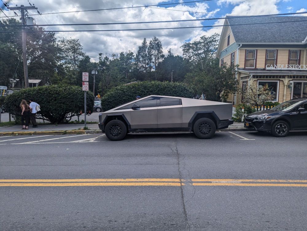 An astonishingly ugly car in a pretty little town.