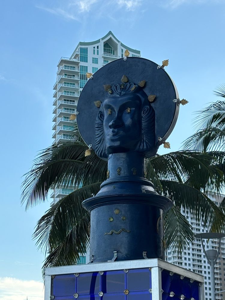 Artwork on Miami Riverwalk. Lady of Miami Statue - Edouard Duval-Carrie. A dark blue head with a halo