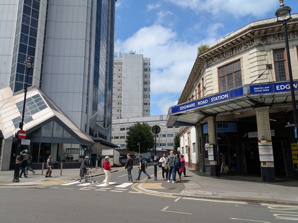 North junction of Chapel and Cabbell Streets. One simple side road zebras without Belisha beacons can be seen with pedestrians crossing. Edgware Road underground station entrance is visible.