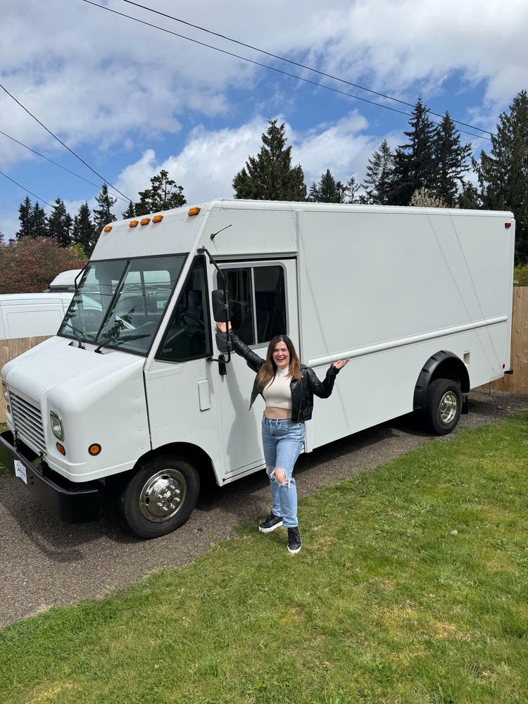 Ash standing in front of a white step van soon to be a bookstore!