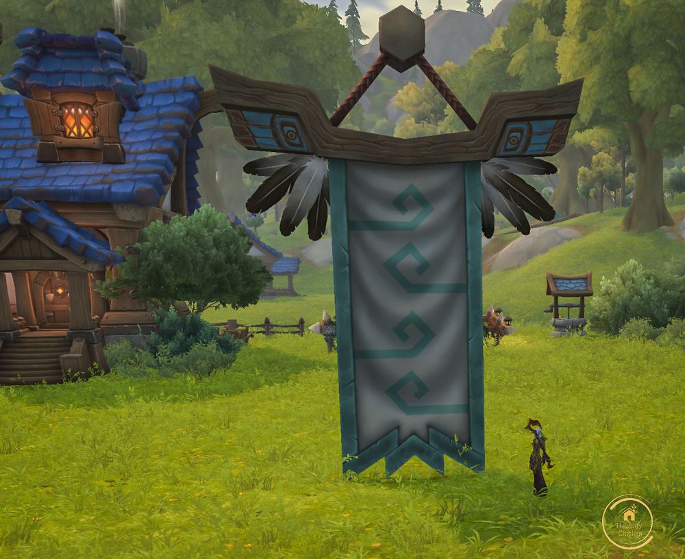 A large tribal banner with feathers and in colours of white and teal.