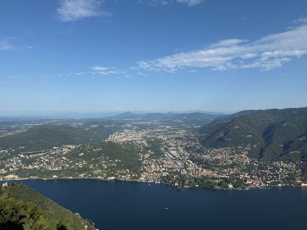 A view across Lake Como towards Chiasso in Switzerland, with mountains in the far distance