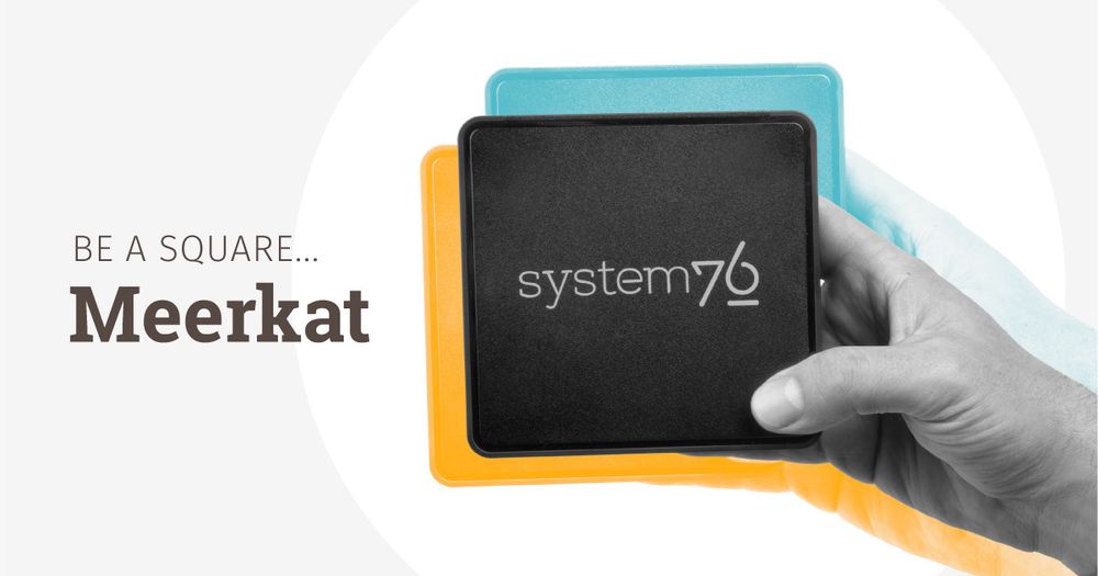 Meerkat Mini PC held up easily in someone's hand. The hand looks bigger than the PC. Caption reads, "Be a square..." referring to the Meerkat's tiny squareness.