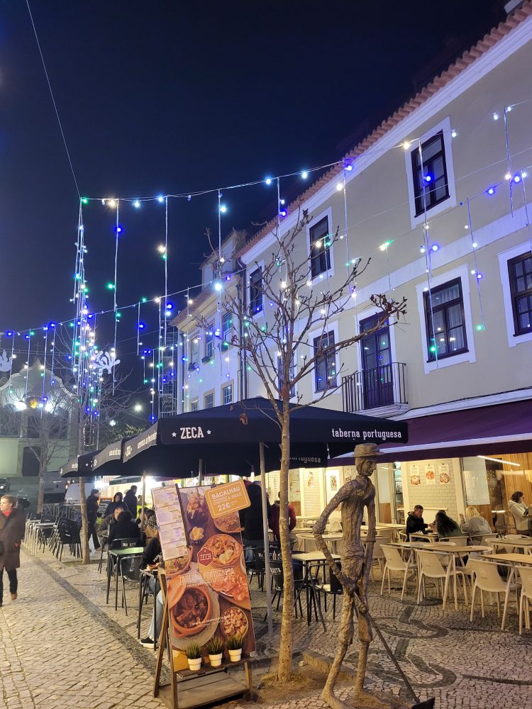 Street in Aveiro with cafes lit up with Xmas lights