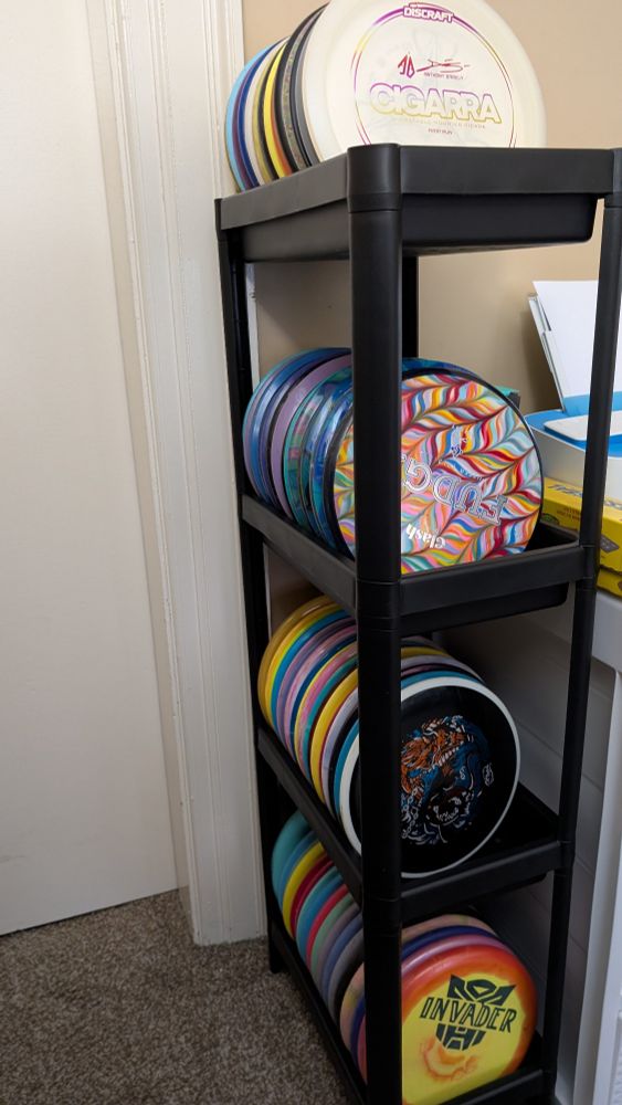 An IKEA Vesken shelf holding 65 disc golf discs with space for 20 more of various disc types