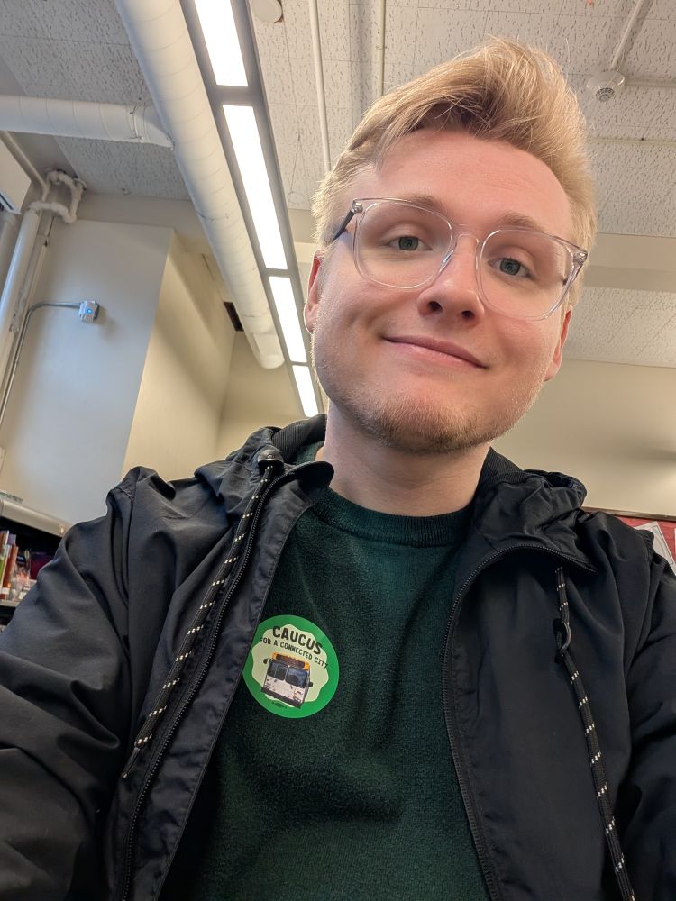 Me sitting with a caucus sticker