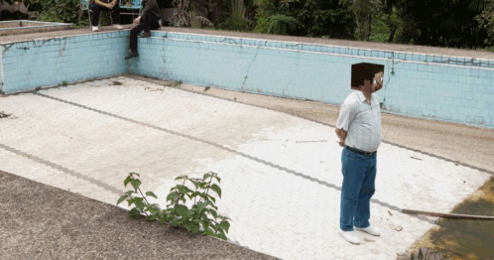 a man standing in front of an empty pool