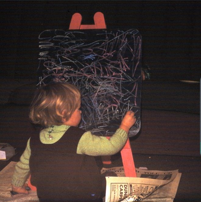 Young artist me creating a masterpiece on my blackboard. Not the lovely home knitted jersey with enormous buttons 😁