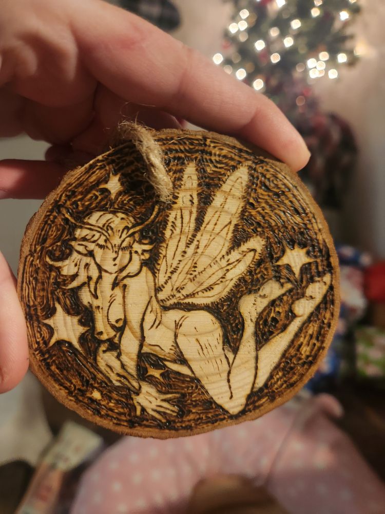 A little fairy with medium length hair, in a gentle pose mid flight