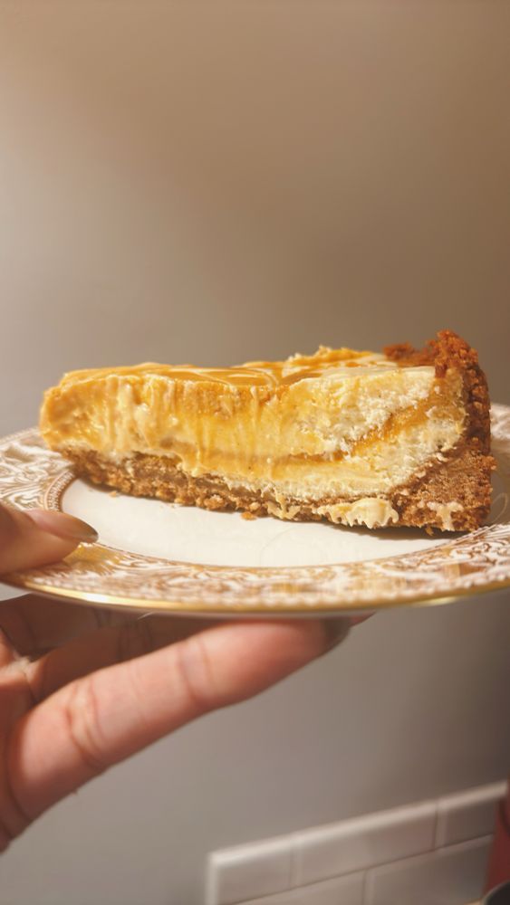 A slice of sweet potato cheesecake on a white plate 