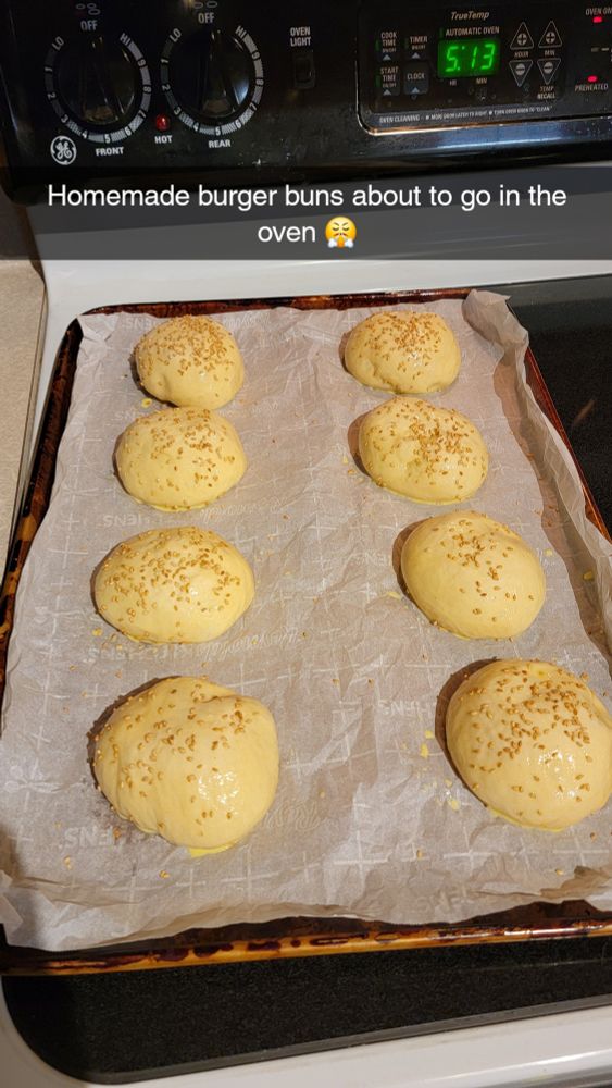 Milk bread burger buns with sesame seeds before being baked