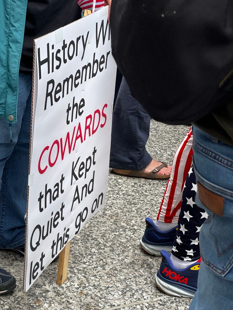 Posted that says “History will remember the cowards that kept quiet and let this go on”