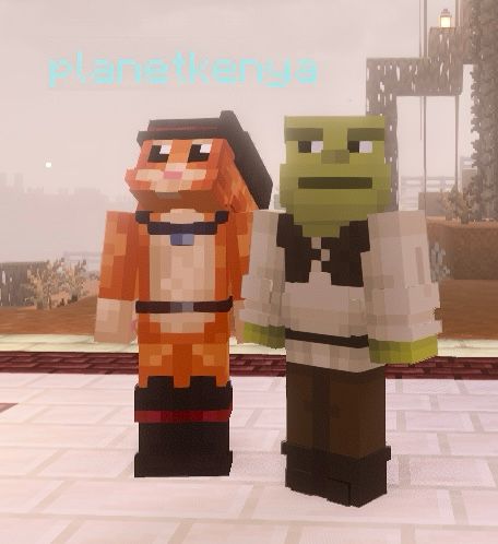 two minecraft characters are standing together in matching skins from the movie Shrek - one is Shrek himself and the other is Puss in Boots! planetkenya is Puss and Soph is Shrek!