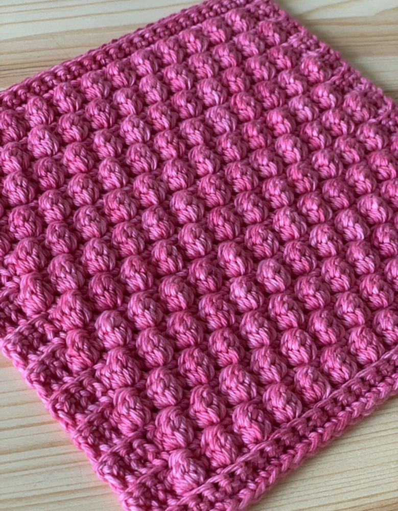 Close up view of dishcloth, showing texture of the bobble stitches 